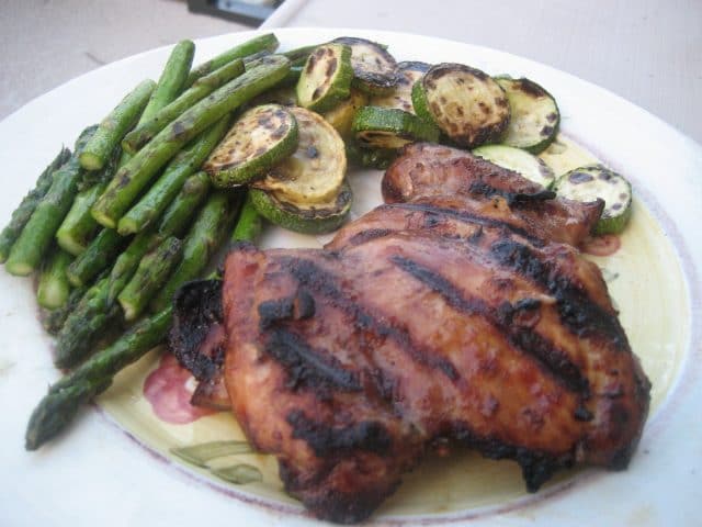 plate with grilled chicken with a side of grilled zucchini and asparagus 