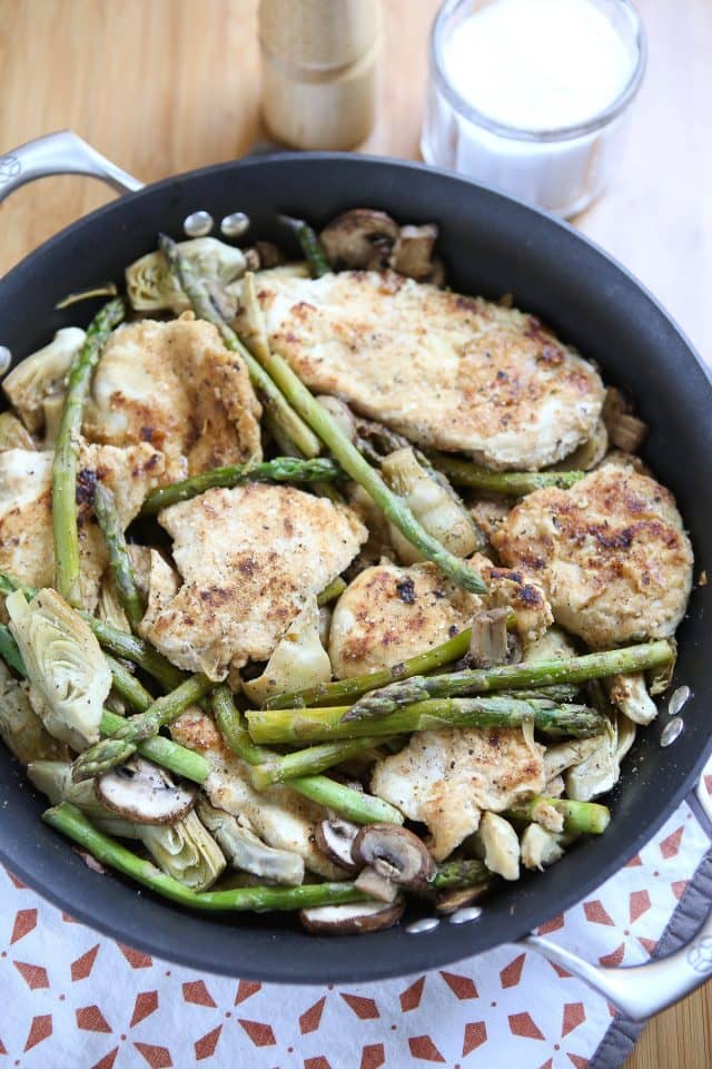 skillet with chicken, artichokes, mushrooms, and asparagus