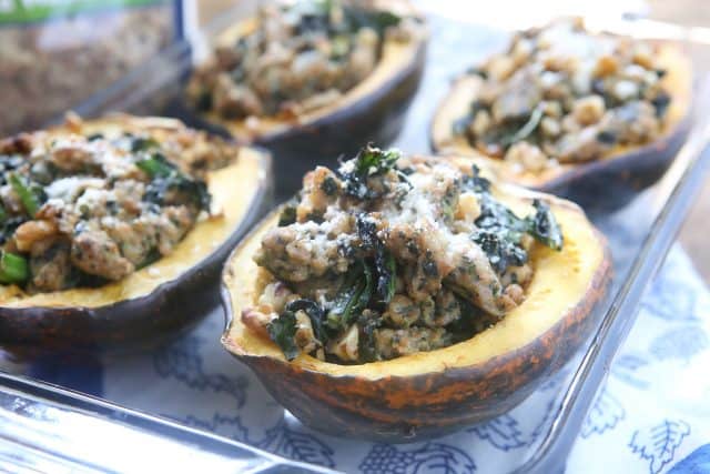 This Stuffed Acorn Squash recipe is filled with hearty ingredients like sausage, kale & walnuts. Makes a great dish for entertaining or healthy meal prep!