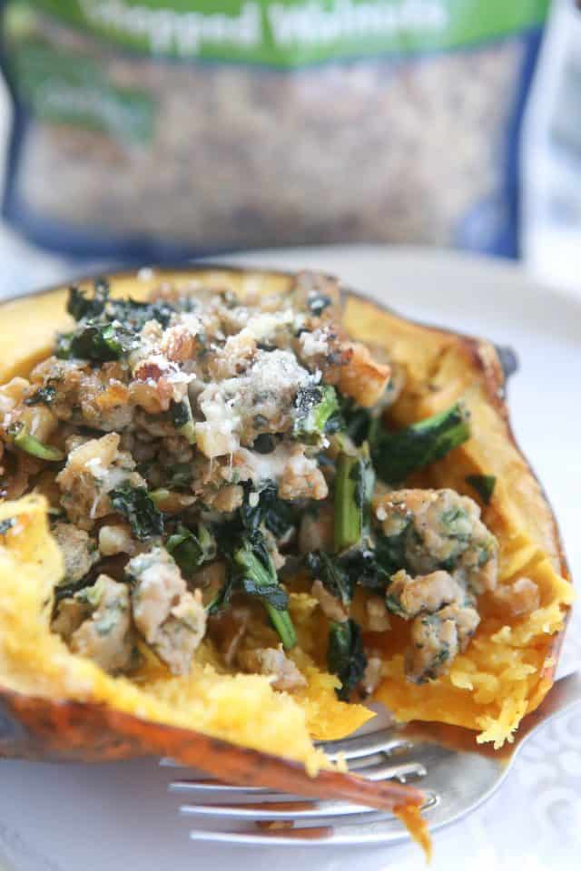 This Stuffed Acorn Squash recipe is filled with hearty ingredients like sausage, kale & walnuts. Makes a great dish for entertaining or healthy meal prep!