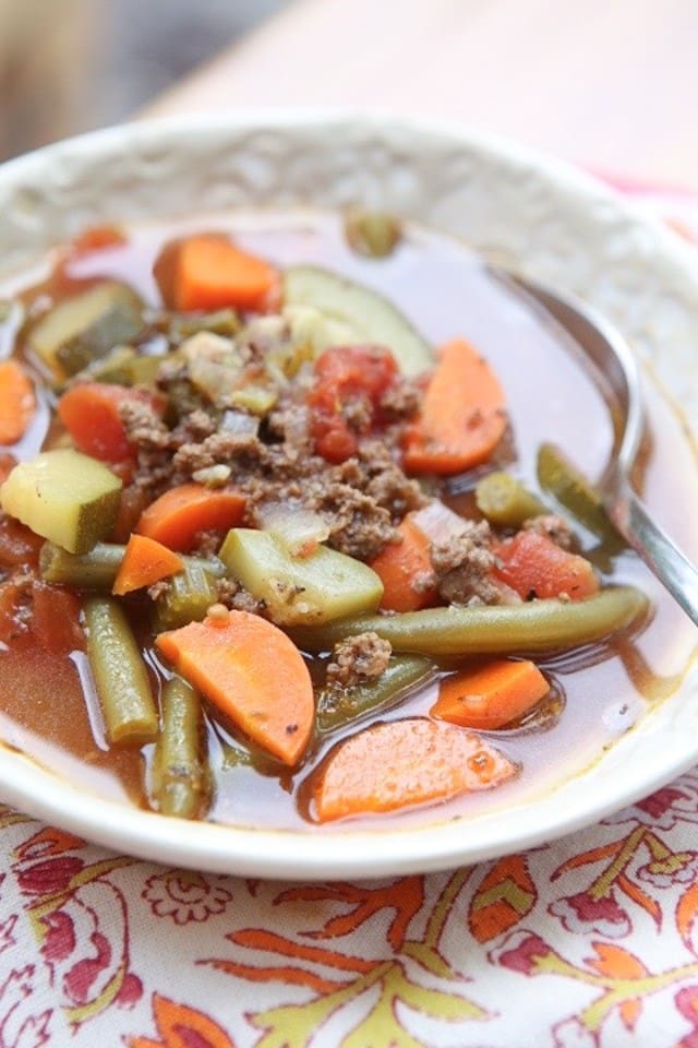 Break out the vegetables for this easy Italian Vegetable Beef Soup recipe. It's loaded with great vegetables like zucchini, squash and carrots. Healthy comfort food! #soup #vegetablesoup #beef #beefrecipe #souprecipe #lowcarbrecipe #healthysouprecipe #healthyrecipe