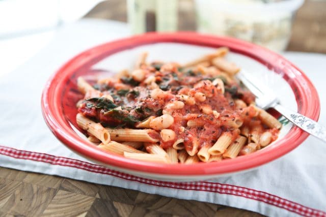 Swiss Chard with White Beans over Pasta - whole wheat pasta, greens and beans make this dish a hearty vegetarian pasta meal! Recipe via aggieskitchen.com