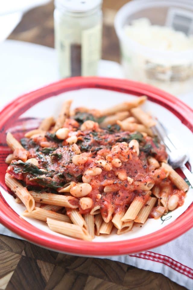 Swiss Chard with White Beans over Pasta - whole wheat pasta, greens and beans make this dish a hearty vegetarian pasta meal! Recipe via aggieskitchen.com