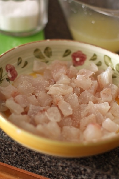 raw fish in a bowl with seasonings 