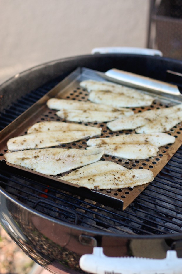 white fish cooking on a grill