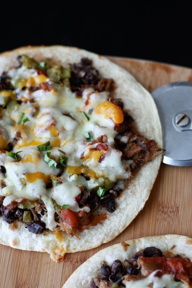 Loaded with pulled pork, beans and cheese this Mexican Black Bean Pizza will satisfy any appetite or craving! Recipe via aggieskitchen.com