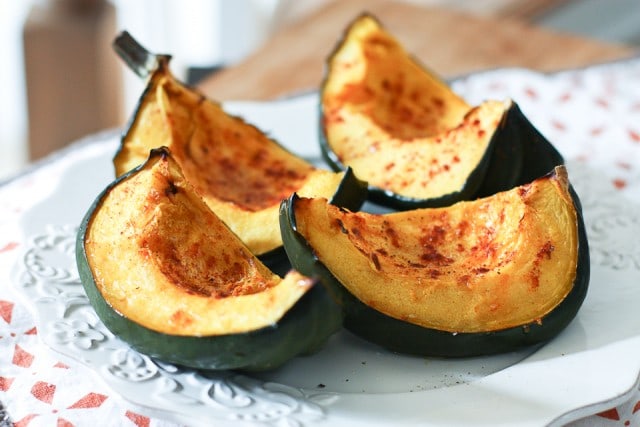 roasted acorn squash wedges on a white plate