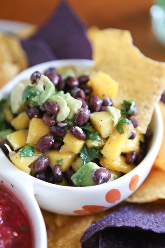 This Mango Avocado and Black Bean Salsa recipe is one you'll want to hang on to! Perfect for dipping with chips, in tacos or over grilled chicken. Recipe via aggieskitchen.com