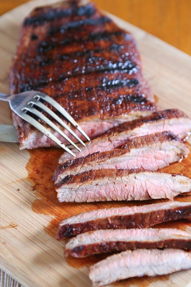 Grilled Flank Steak seasoned with a flavorful blend of brown sugar, chili powder, smoked paprika & cinnamon - fire up your grill for this one this weekend!