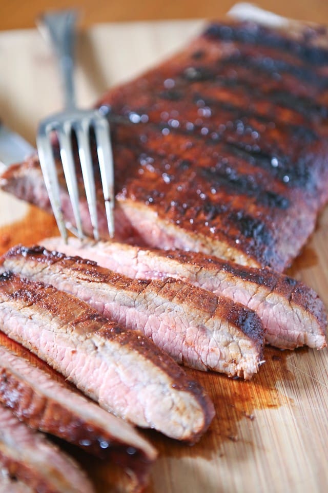 Grilled Flank Steak seasoned with a flavorful blend of brown sugar, chili powder, smoked paprika & cinnamon - fire up your grill for this one this weekend!