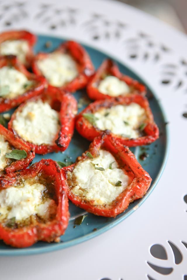 A simple, yet impressive, side dish or appetizer - roasted red peppers with pesto and goat cheese are full of flavor and a delicious addition to any meal.