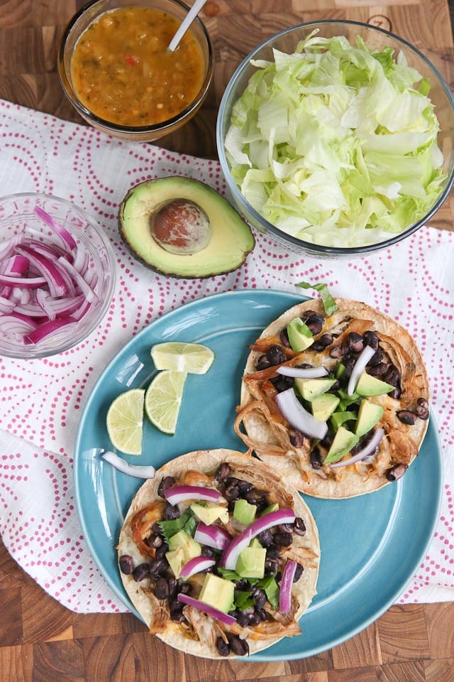 Slow Cooker Salsa Verde Pork Tostadas - all you need is a few ingredients and a little help from your slow cooker to put together this delicious, healthy baked tostada dinner your whole family will love.