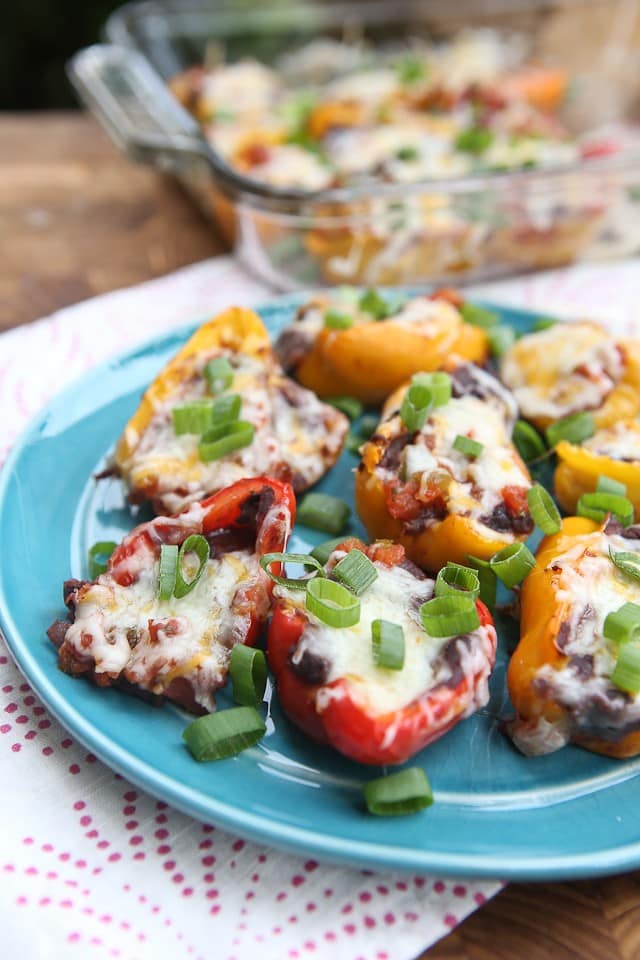 Mini Mexican Stuffed Peppers - baby bell peppers stuffed with black refried beans, salsa and cheese. Great side dish or appetizer and hard to resist! Recipe via aggieskitchen.com