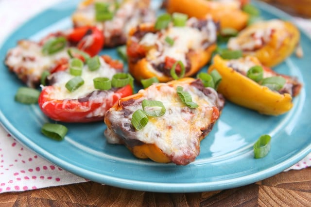 Mini Mexican Stuffed Peppers - baby bell peppers stuffed with black refried beans, salsa and cheese. Great side dish or appetizer and hard to resist! Recipe via aggieskitchen.com