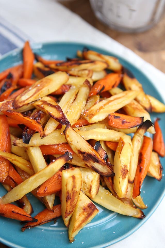 roasted carrot and parsnip sticks on blue plate