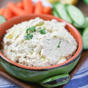 A great healthy snack or appetizer - grab your pita chips or veggies for this Lemony Artichoke Hummus dip.