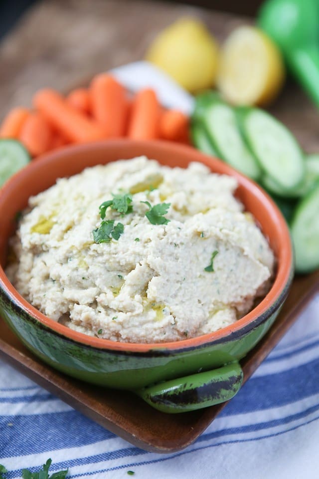 A great healthy snack or appetizer - grab your pita chips or veggies for this Lemony Artichoke Hummus dip.