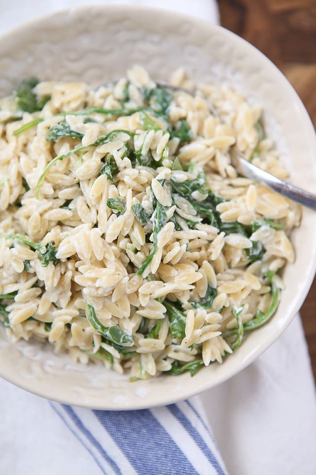 A simple side dish that is full of flavor! Creamy goat cheese and fresh arugula combined with warm orzo, your whole family will love this one.