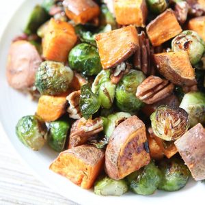 All the flavors of fall on a plate! Drizzled with a maple, balsamic and sriracha glaze....you'll love these Roasted Sweet Potatoes and Brussels Sprouts with Pecans #ThinkFisher