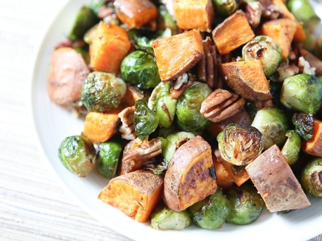 All the flavors of fall on a plate! Drizzled with a maple, balsamic and sriracha glaze....you'll love these Roasted Sweet Potatoes and Brussels Sprouts with Pecans #ThinkFisher