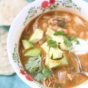All the goodness of chicken tortilla soup (but with white chili beans!) made in your slow cooker! Pile on the toppings and make it your own - perfect for family dinner or entertaining on cool fall or winter nights.