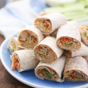 Lightened up party food! These Buffalo Hummus Chicken Salad Roll Ups are the perfect recipe to add to your next casual entertaining menu. Great for lunches too!