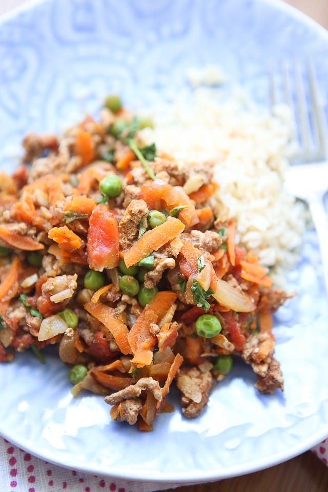 plate of rice and ground turkey with carrots, peas, and onions
