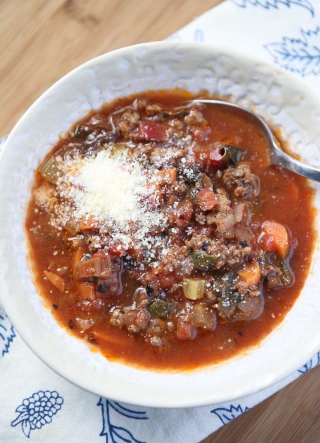 bowl of vegetable beef soup with parmesan cheese