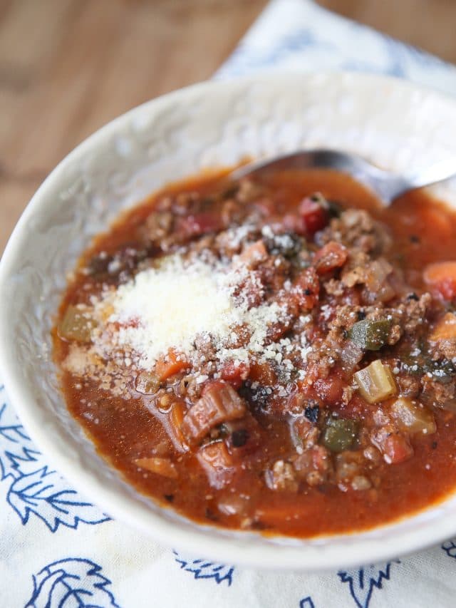 bowl of vegetable beef soup with parmesan cheese