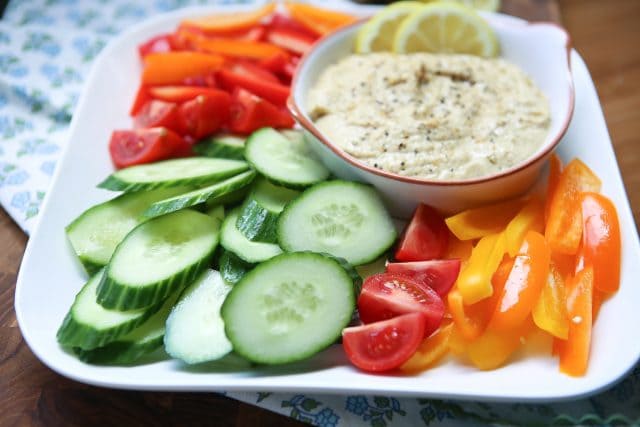 In need of an easy appetizer? Everyone loves a veggie plate! Spruce it up by serving fresh veggies with semi-homemade Lemon Pepper Hummus. Recipe via aggieskitchen.com #UnofficalMeal #NationalHummusDay
