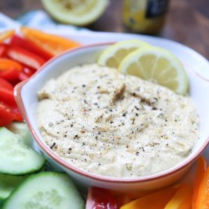 In need of an easy appetizer? Everyone loves a veggie plate! Spruce it up by serving fresh veggies with semi-homemade Lemon Pepper Hummus. Recipe via aggieskitchen.com #UnofficalMeal #NationalHummusDay