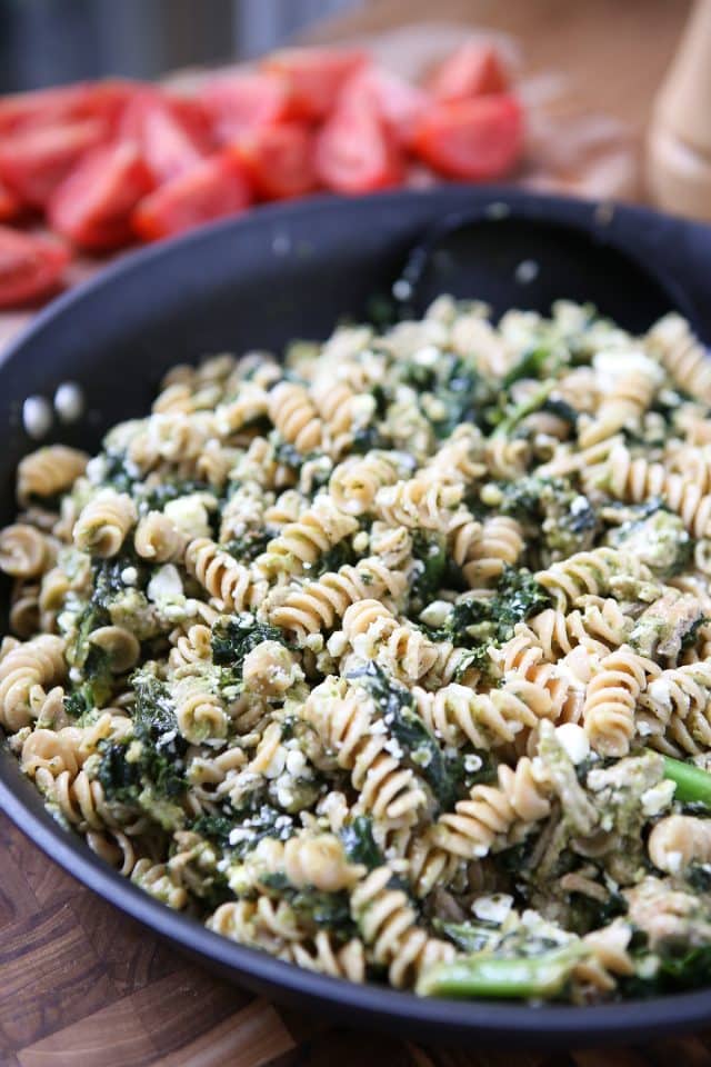 nonstick skillet filled with cooked pasta, pesto, kale and ground turkey