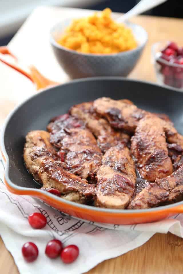 skillet of chicken topped with cranberry balsamic dressing