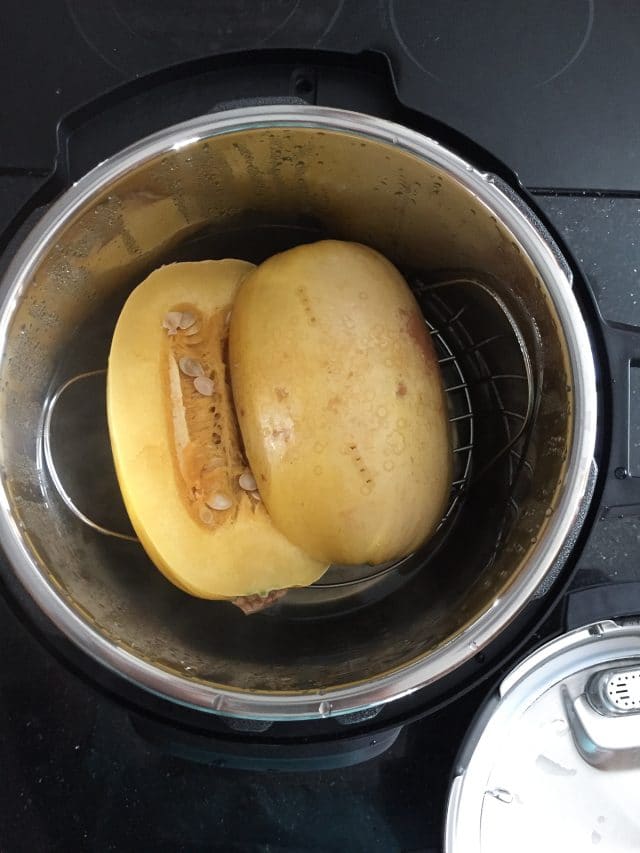 two spaghetti halves in bowl of instant pot before cooking