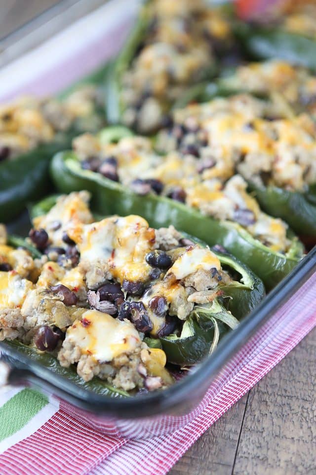 Only 5 ingredients to make these delicious Stuffed Poblano Peppers with Turkey and Black Beans! A light, healthy dinner perfect for weeknights. Leftovers make for great lunches too! Recipe via aggieskitchen.com