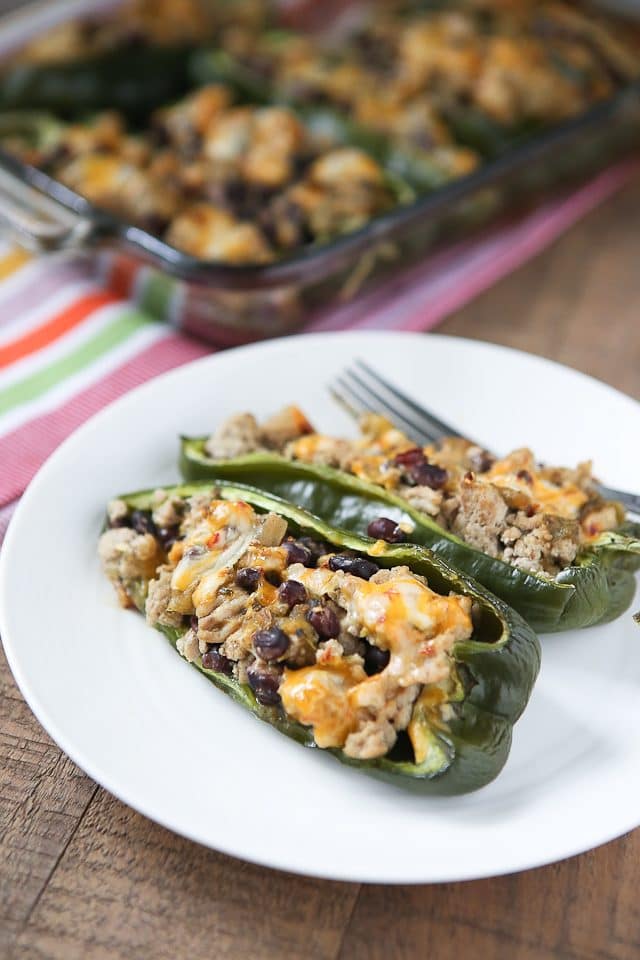 Only 5 ingredients to make these delicious Stuffed Poblano Peppers with Turkey and Black Beans! A light, healthy dinner perfect for weeknights. Leftovers make for great lunches too! Recipe via aggieskitchen.com