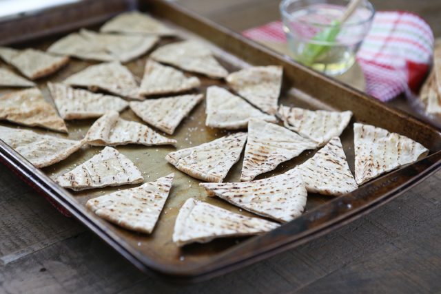 sheet pan filled with pita triangles before baking