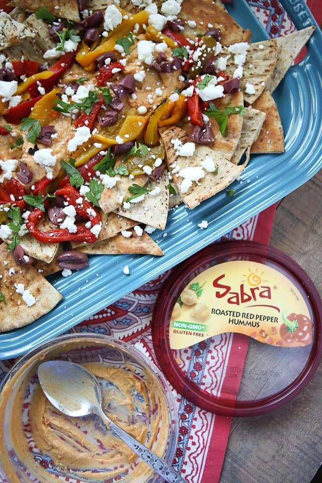 Say hello to your new favorite appetizer! Mediterranean Nachos with Roasted Red Pepper Hummus is what you could call a beautiful mess of all the flavors I love in this world. Topped with Sabra Hummus, roasted peppers, olives, feta and fresh herbs, you can't go wrong with this one! Recipe via aggieskitchen.com