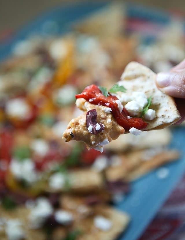 Say hello to your new favorite appetizer! Mediterranean Nachos with Roasted Red Pepper Hummus is what you could call a beautiful mess of all the flavors I love in this world. Topped with Sabra Hummus, roasted peppers, olives, feta and fresh herbs, you can't go wrong with this one! Recipe via aggieskitchen.com