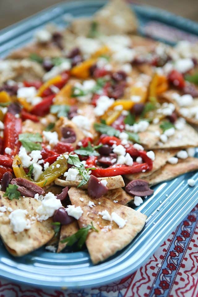 Say hello to your new favorite appetizer! Mediterranean Nachos with Roasted Red Pepper Hummus is what you could call a beautiful mess of all the flavors I love in this world. Topped with Sabra Hummus, roasted peppers, olives, feta and fresh herbs, you can't go wrong with this one! Recipe via aggieskitchen.com