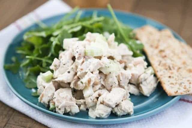 plate of chicken salad with spinach and crackers