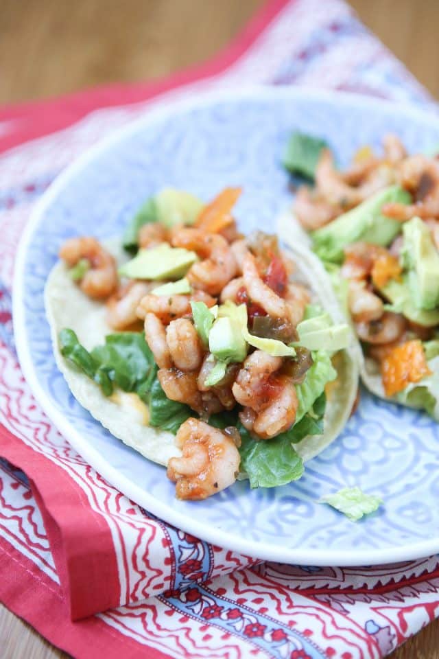 plate of two tortillas stuffed with shrimp, lettuce, and avocado