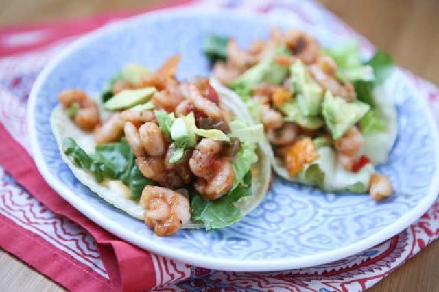 plate of two tortillas stuffed with shrimp, lettuce, and avocado