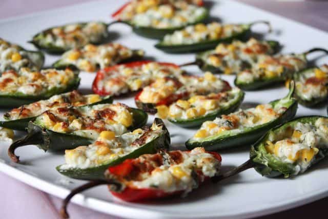 white plate filled with cheese and corn stuffed jalapenos