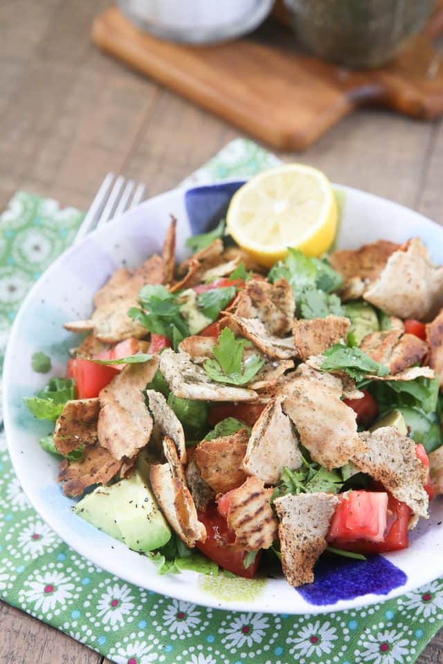 Lebanese-inspired Fattoush Salad filled with fresh garden vegetables, herbs & toasted pita pieces, dressed with lemon & olive oil.