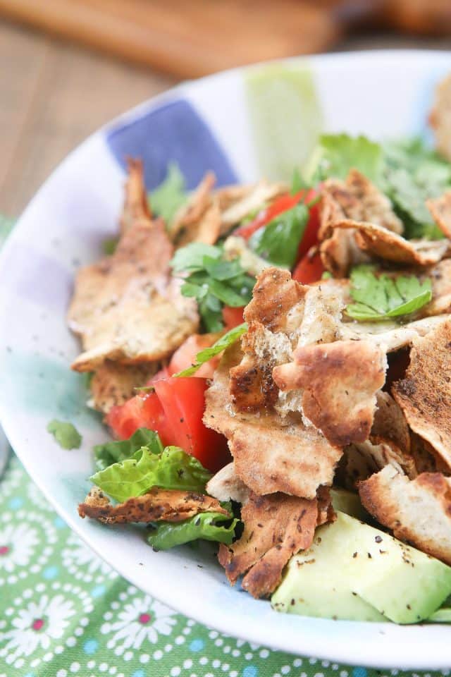 Lebanese-inspired Fattoush Salad filled with fresh garden vegetables, herbs & toasted pita pieces, dressed with lemon & olive oil.