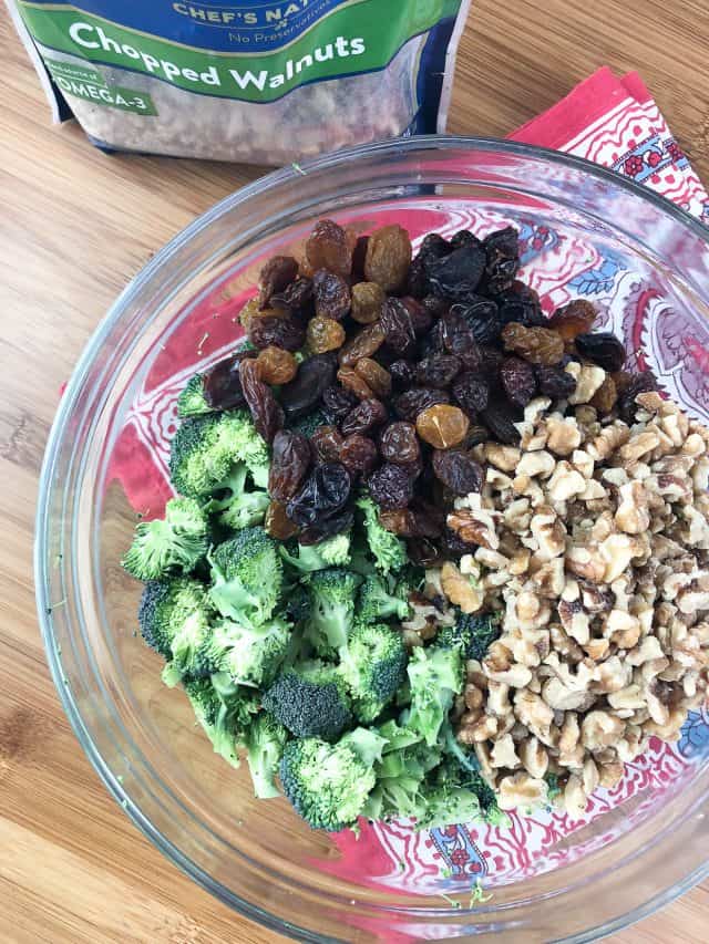Need a side dish for summer entertaining? I've got you covered with this simple Broccoli and Raisin Salad with Walnuts. #ThinkFisher #broccoli #salad #carrots #salad #walnuts #picnic
