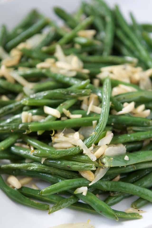 close up of green beans with almonds